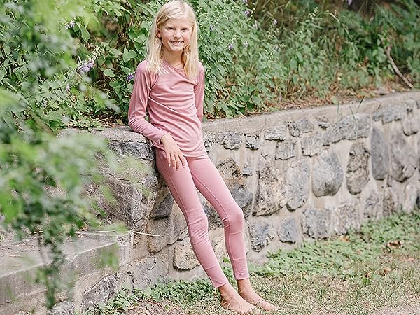 Girl wearing a Woolino Kids Merino Wool Thermal Top and Legging in Blush pink.