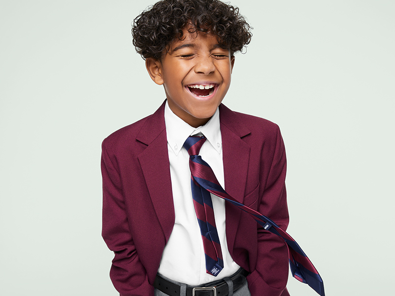 Boy smiling in blazer and tie