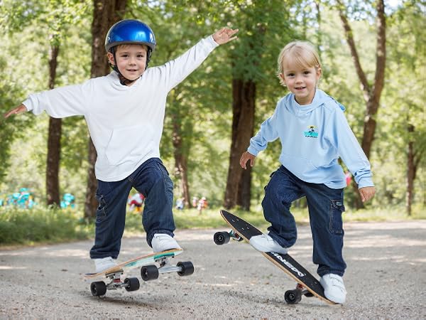 girl boy wearing UV protection sun hoodies are skateboarding in the middle of summer