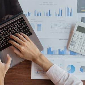 Man working on laptop with finances