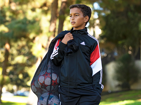 Young boy model sporting adidas Youth Apparel